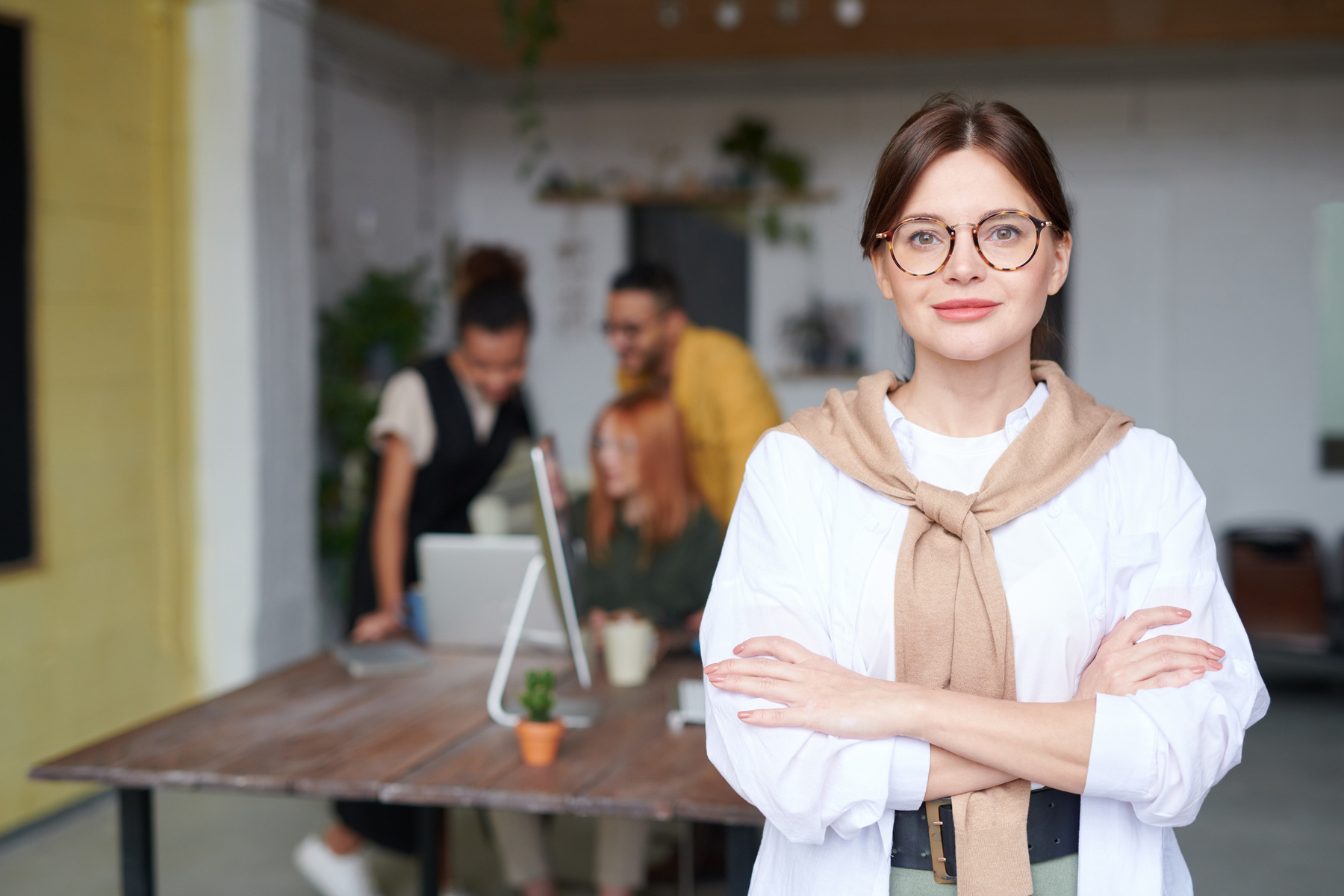 Mature businesswoman in the office with colleagues in the background